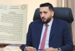 صورة تعبيرية تجمع بين منشور رسمي صادِر عن وزارة الاقتصاد والتجارة بحكومة الوحدة الوطنية ومسؤول بالوزارة أثناء عمله.