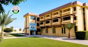 مبنى الإدارة العامة لجامعة الزيتونة في ترهونة محاطاً بمساحات خضراء وأشجار نخيل مع شعار الجامعة.